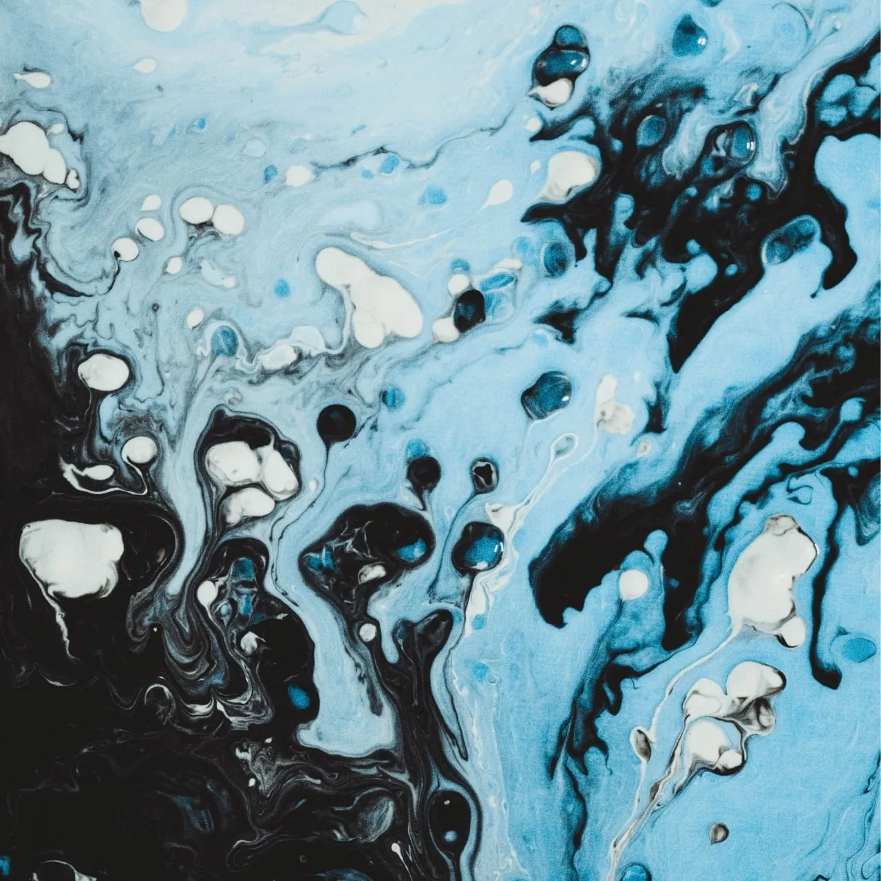 An acrylic painting with dark brown and bright blue color palette displaying droplets of paint merging