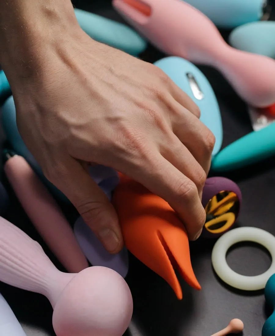 A male hand grabbing one of many vibrators