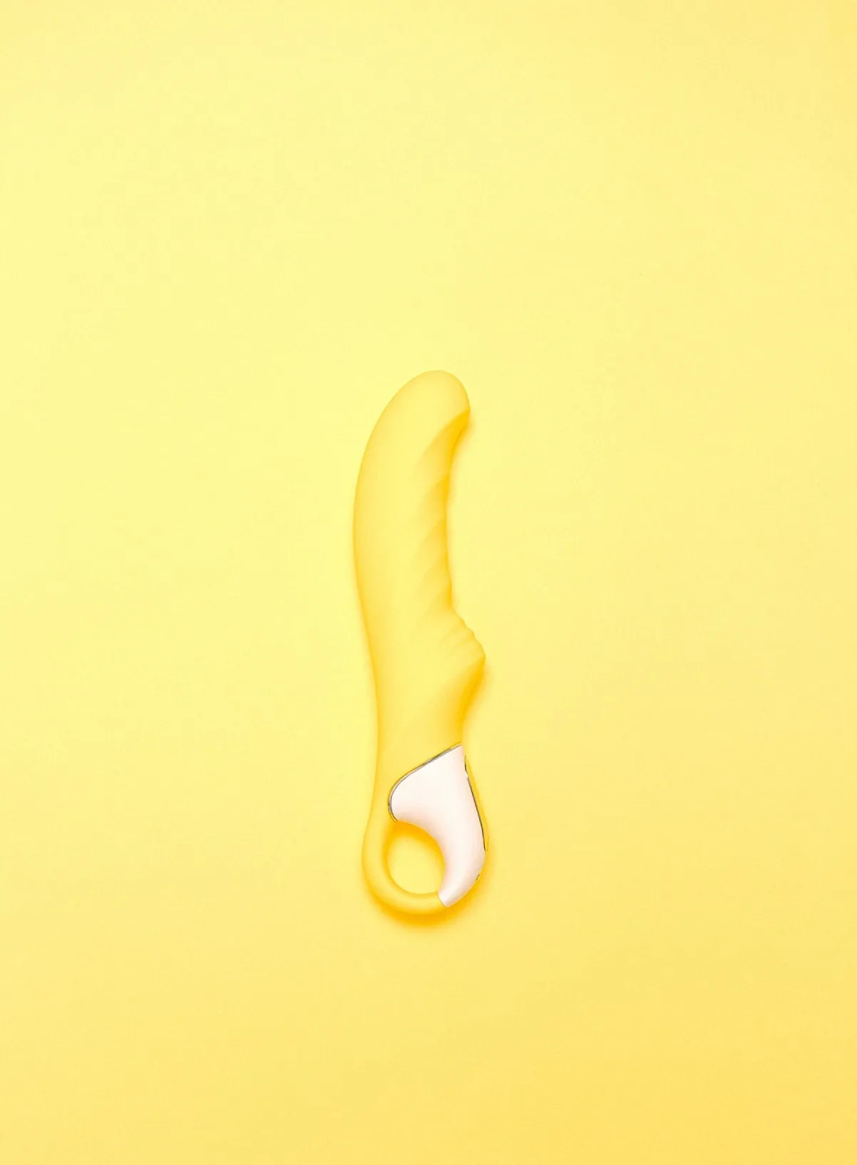 A yellow vibrator on a yellow background